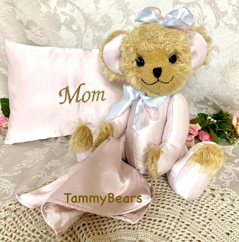 Memory teddy bear made from pink satin and pluch fur.