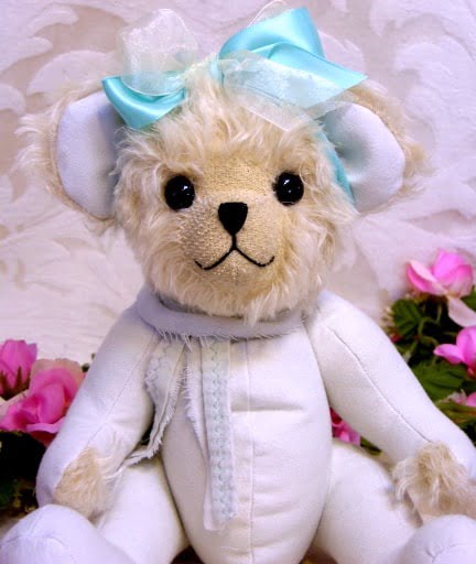 Bear made from white clothing with bow.