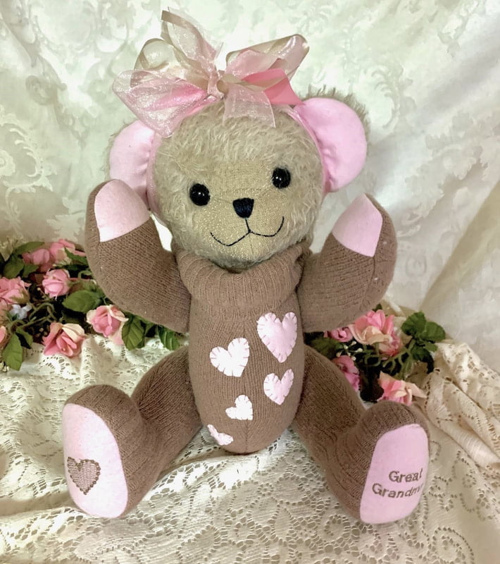Memorial teddy ber made from tan sweater with pink hearts.