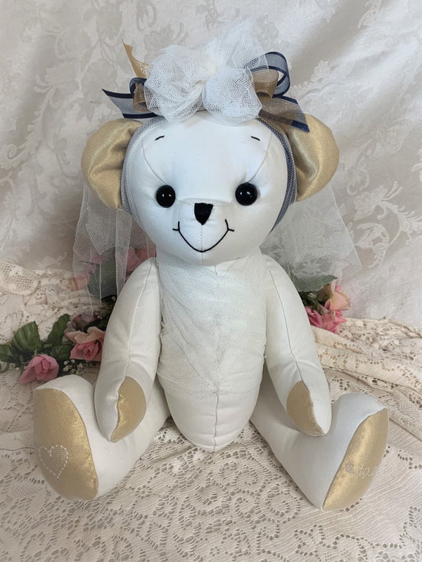 Wedding dress bear with gold and black bows.