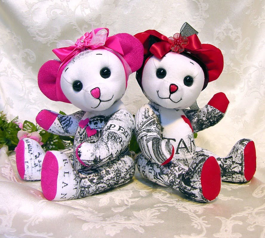 Two bears made from white with pink and red bows.