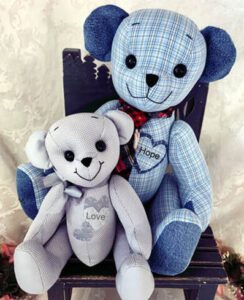 Memory teddy bears made out of plaid and gray shirts.