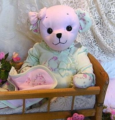 Pink baby bear in crib.