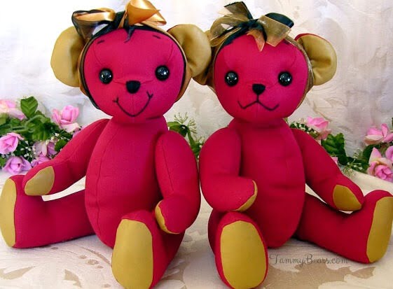 Two happy bears made from red shirt with gold bows.