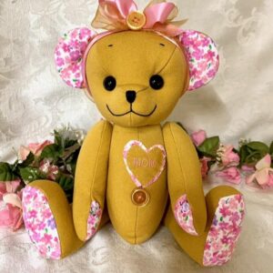 Memory bear made from floral shirt and yellow clothing with pink bow.