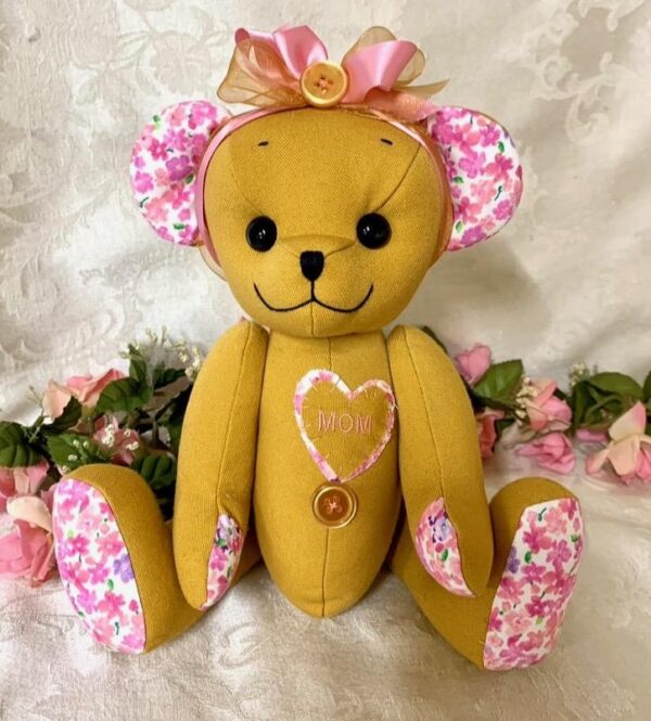 Memory bear made from floral shirt and yellow clothing with pink bow.