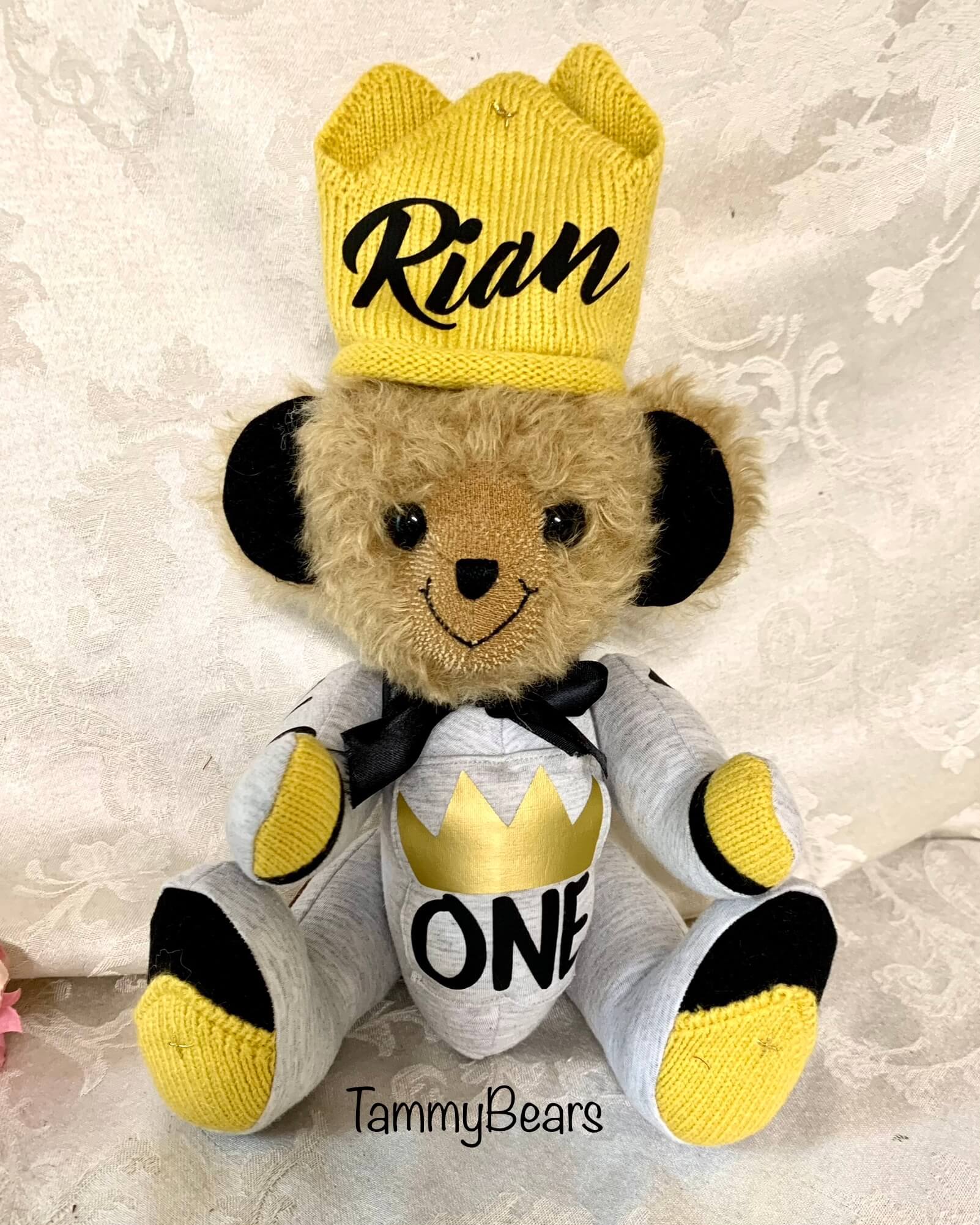 Part plush teddy bear made from baby gray and gold clothing.